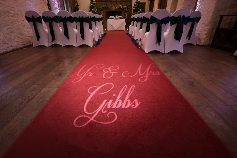 Wedding aisle red carpet with monogram of the bride and groom's name