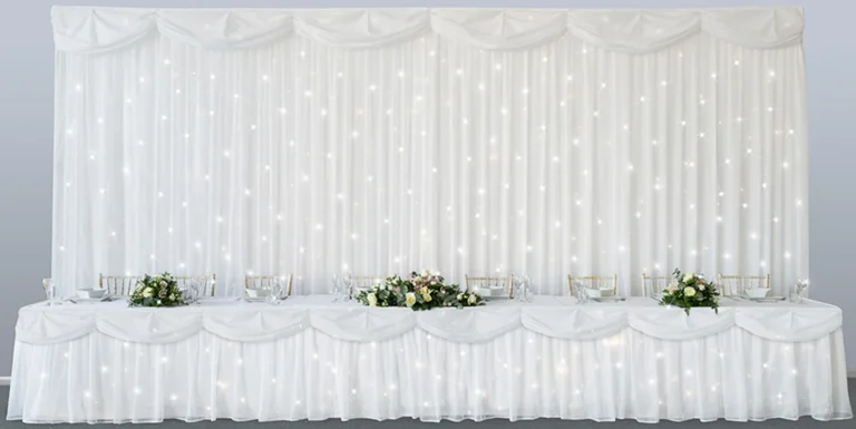 An isolated picture of our fibre optic starlit backdrop at the main table of a wedding reception.