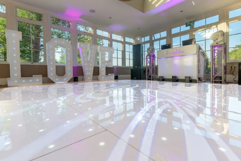 Stunning wedding reception room with LED starlit dance floor and mobile disco setup ready for the bride and groom's first dance.