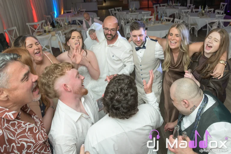 Packed wedding dance floor at New House Country Hotel with guests singing and celebrating