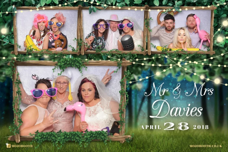 Photo booth template of forest midnight garden with romantic string lights encapsulates the bride and wedding guests at their reception. Everyone is having fun and wearing whacky props.